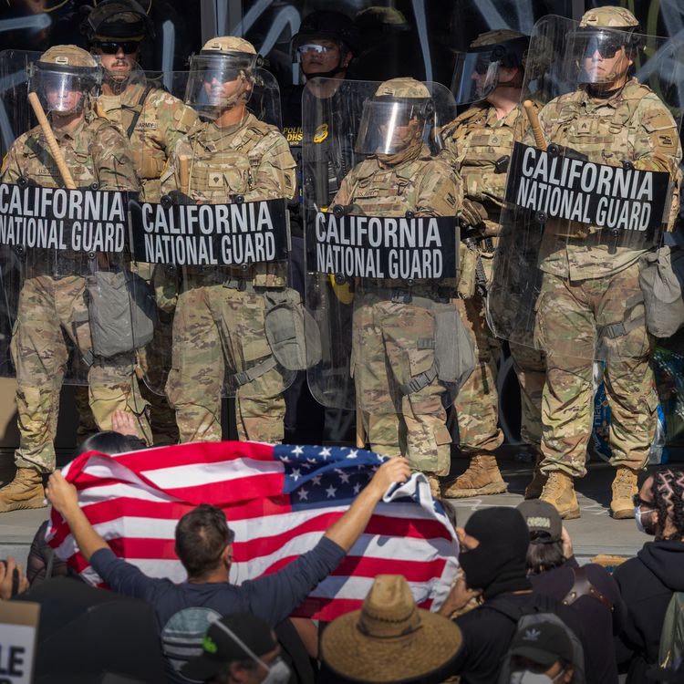 cover art for What’s behind Trump’s show of force in LA?