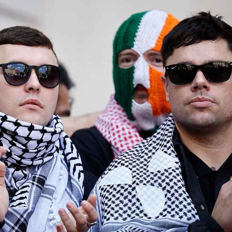 cover art for 5387: LISTEN¦ The Prime Minister says Kneecap appearing at Glastonbury is 'inappropriate' - what do you think? Has the response of politicians helped or hindered the popularity of the west Belfast rap group? Frank spoke to Mick Fealty