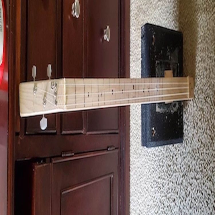 cover art for Demonsrating a cigar box guitar with a "hum bucker" pickup