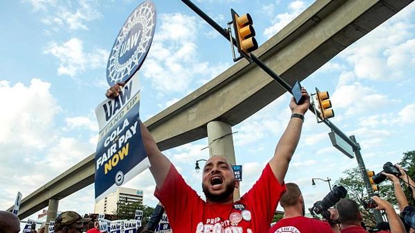 cover art for U.S. auto union threatens wider strike amid wage dispute
